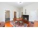 Classic dining room featuring hardwood floors, natural light, and a decorative fireplace at 14006 5Th St, Dade City, FL 33525