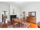 Traditional dining room featuring hardwood floors, fireplace, and round wooden table at 14006 5Th St, Dade City, FL 33525