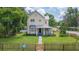 Charming two-story home with a well-manicured lawn and a classic picket fence at 14006 5Th St, Dade City, FL 33525