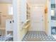 Hallway with patterned tile flooring that connects the bathroom and entrance at 14006 5Th St, Dade City, FL 33525