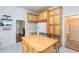 Bright kitchen featuring wood cabinetry, white appliances, and patterned tile flooring at 14006 5Th St, Dade City, FL 33525