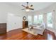 Bright living room with hardwood floors, a ceiling fan, and ample natural light at 14006 5Th St, Dade City, FL 33525