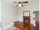 Cozy living room with a fireplace, hardwood floors, and a ceiling fan at 14006 5Th St, Dade City, FL 33525