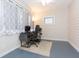 Comfortable home office with gray painted floors and modern computer setup at 14006 5Th St, Dade City, FL 33525