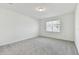 Bright bedroom with neutral carpet, a window with blinds, and ample natural light at 20783 Balsam Hill Rd, Land O Lakes, FL 34638