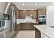 Stylish kitchen with stainless steel refrigerator and range hood, paired with warm wood cabinets at 20783 Balsam Hill Rd, Land O Lakes, FL 34638