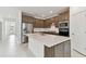 Modern kitchen featuring stainless steel appliances, a center island, and wood cabinetry at 20783 Balsam Hill Rd, Land O Lakes, FL 34638