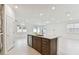 Modern kitchen featuring a center island with stainless steel dishwasher in an open floor plan at 20783 Balsam Hill Rd, Land O Lakes, FL 34638