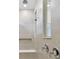 Modern tiled shower area features built-in bench and window, along with updated shower head at 20783 Balsam Hill Rd, Land O Lakes, FL 34638