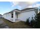 Rear view of the home showing a covered patio and landscaping at 7316 Donnybrook Ln, Sarasota, FL 34240