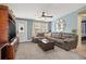 Cozy living room featuring a brown sectional sofa, a coffee table, and built-in shelving at 10526 119Th Ave, Largo, FL 33773