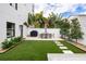 Modern backyard with artificial turf, patio furniture, and grill at 2506 N Highland Ave, Tampa, FL 33602