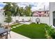 Landscaped backyard oasis with seating area and playhouse at 2506 N Highland Ave, Tampa, FL 33602