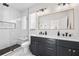Modern bathroom with marble tile, double vanity, and walk-in shower at 2506 N Highland Ave, Tampa, FL 33602