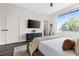 Spacious bedroom with large window, TV, and neutral decor at 2506 N Highland Ave, Tampa, FL 33602