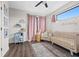 Bedroom with a crib, seating area, and natural light at 2506 N Highland Ave, Tampa, FL 33602