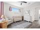 Bedroom with a crib, seating area, and natural light at 2506 N Highland Ave, Tampa, FL 33602