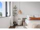 Bedroom with a large window, neutral tones, and stylish decor at 2506 N Highland Ave, Tampa, FL 33602