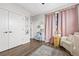 Bedroom with pink curtains, crib, and plenty of natural light at 2506 N Highland Ave, Tampa, FL 33602