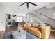 Open concept living space with contemporary furnishings and staircase at 2506 N Highland Ave, Tampa, FL 33602