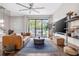 Spacious living room with large TV, comfortable sofa, and access to balcony at 2506 N Highland Ave, Tampa, FL 33602
