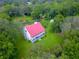 Aerial view of a house with red roof and large backyard at 4502 Hill Dr, Valrico, FL 33596