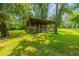 Rustic wooden animal shelter in a lush green pasture at 4502 Hill Dr, Valrico, FL 33596
