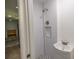 Small, updated basement bathroom with a shower and pedestal sink at 4502 Hill Dr, Valrico, FL 33596