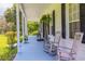 Relaxing front porch with rocking chairs and lush greenery at 4502 Hill Dr, Valrico, FL 33596