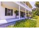 Spacious front porch with white columns and rocking chairs at 4502 Hill Dr, Valrico, FL 33596