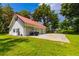 Spacious three-car garage with a red roof and ample parking space at 4502 Hill Dr, Valrico, FL 33596