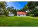 Detached garage with red metal roof and ample space at 4502 Hill Dr, Valrico, FL 33596