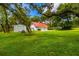 Detached three-car garage with a red metal roof at 4502 Hill Dr, Valrico, FL 33596