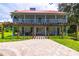 Two-story home with a red roof, large porch, and pergola at 4502 Hill Dr, Valrico, FL 33596