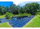 Landscaped area with various plants and trees in pots at 4502 Hill Dr, Valrico, FL 33596