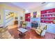 Living room with hardwood floors, built-ins, fireplace, and view of staircase at 4502 Hill Dr, Valrico, FL 33596