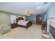 Large main bedroom with a king-size bed, fireplace, and ample space at 4502 Hill Dr, Valrico, FL 33596