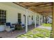 Relaxing patio area with pergola, comfortable seating, and lush landscaping at 4502 Hill Dr, Valrico, FL 33596
