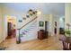 Elegant staircase with wooden railings and chandelier at 4502 Hill Dr, Valrico, FL 33596
