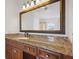 Elegant bathroom vanity with granite countertop and large mirror at 8932 Rocky Creek Dr, Tampa, FL 33615