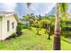 Landscaped backyard with palm trees and canal view at 1501 63Rd W St, Bradenton, FL 34209
