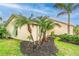 Side view of the home with green shutters and palm trees at 1501 63Rd W St, Bradenton, FL 34209