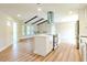 Modern kitchen with white cabinets, island, and stainless steel appliances at 1501 63Rd W St, Bradenton, FL 34209