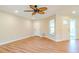 Spacious living room with hardwood floors, ceiling fan, and access to exterior at 1501 63Rd W St, Bradenton, FL 34209