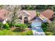 Aerial view of a two-story house with a landscaped yard and driveway at 9083 Quail Creek Dr, Tampa, FL 33647