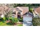 Aerial view of a two-story house with a landscaped yard and driveway at 9083 Quail Creek Dr, Tampa, FL 33647