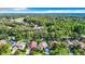 Aerial view showcasing a neighborhood with lush green trees and houses at 9083 Quail Creek Dr, Tampa, FL 33647