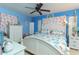 Main bedroom with coastal bedding and a ceiling fan at 315 E Seneca Ave, Tampa, FL 33612