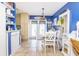 Kitchen with white cabinets, a dining area, and French doors at 315 E Seneca Ave, Tampa, FL 33612