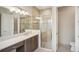 Modern bathroom featuring a glass shower, dual vanity, and sleek design at 4838 Sevilla Shores Dr, Wimauma, FL 33598